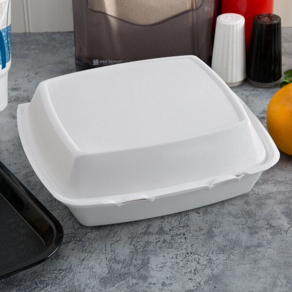 A Dart white foam hinged lid takeout container.
