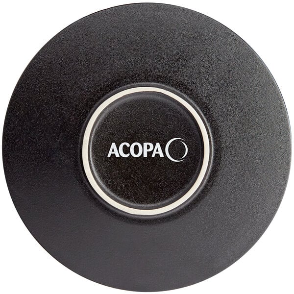 A black stoneware plate with a white circle and the word Acopa in white text.