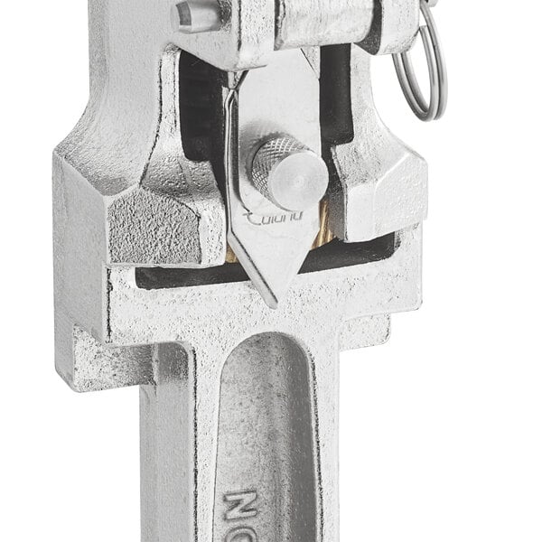 The stainless steel base of an Edlund commercial can opener with a metal clamp and key.