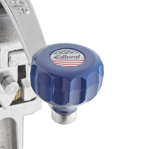 A close-up of the blue and white plastic knob on an Edlund #1 Manual Can Opener.