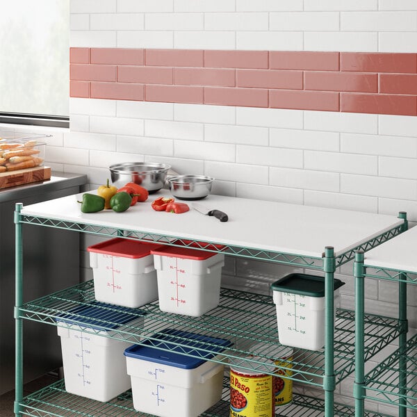 A white Regency Polyethylene cutting board on a wire shelf above food.