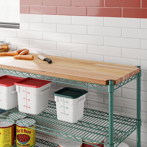 A Regency hardwood cutting board insert on a wooden wire shelf above a can of beans.