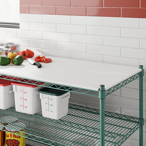 A Regency polyethylene cutting board insert on a wire shelf over food.