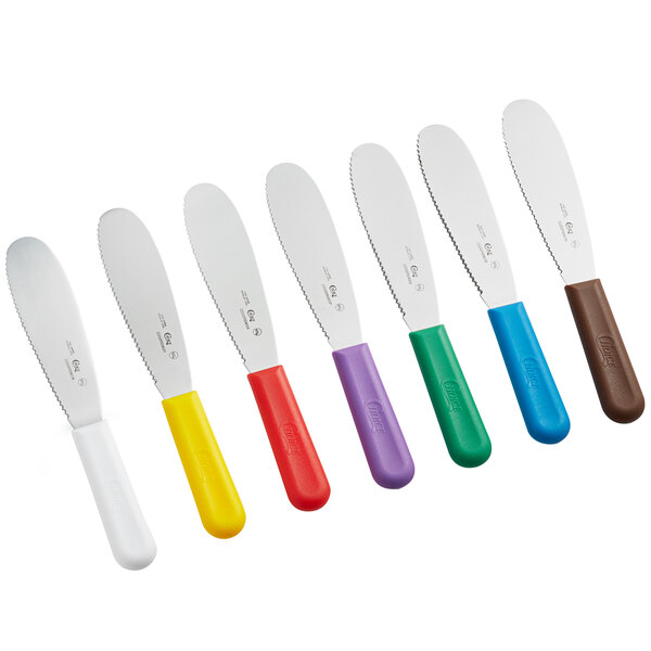 A set of Choice sandwich spreaders with scalloped edges and colored handles.