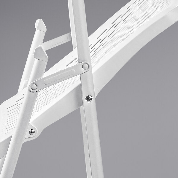 A white plastic National Public Seating AirFlex folding chair with a metal frame.