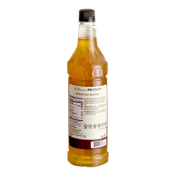 A 1-liter bottle of Monin Zero Calorie Natural Hazelnut Flavoring Syrup with a black cap.