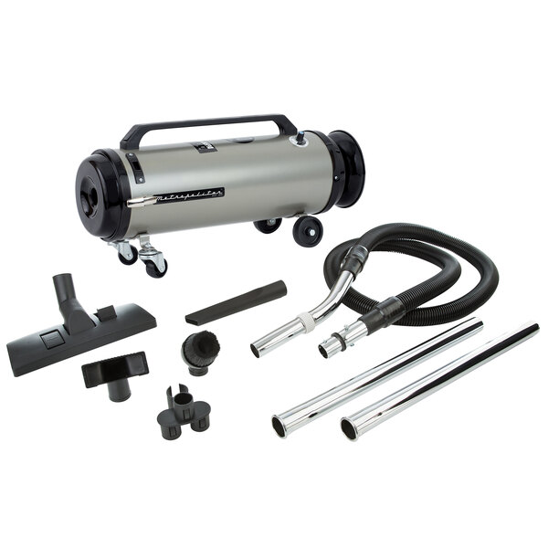 A MetroVac Professional Evolution canister vacuum with hose and accessories.