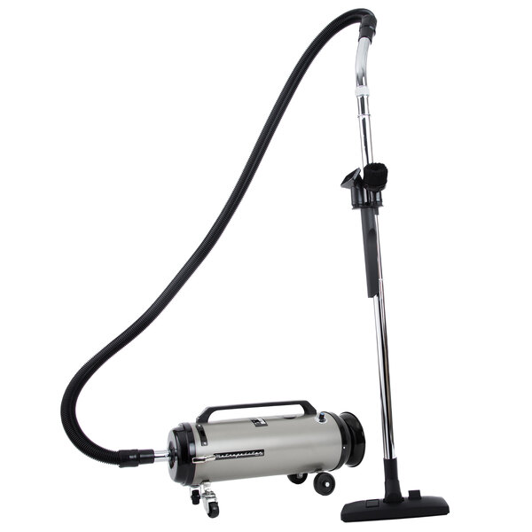 A MetroVac Professional Evolution canister vacuum with a long hose.