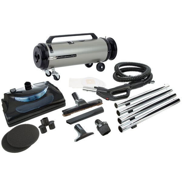 A grey MetroVac canister vacuum with black wheels and accessories.