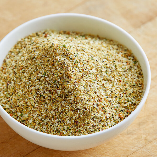 A bowl of Lawry's Garlic, Rosemary, and Lemon Rub on a wood surface.