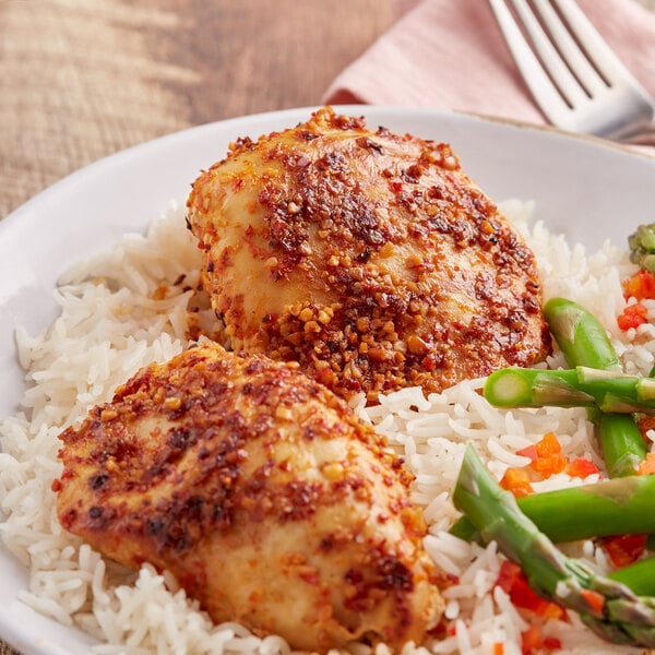 A plate of rice, asparagus, and chicken seasoned with Lawry's Roasted Garlic and Red Bell Pepper seasoning.