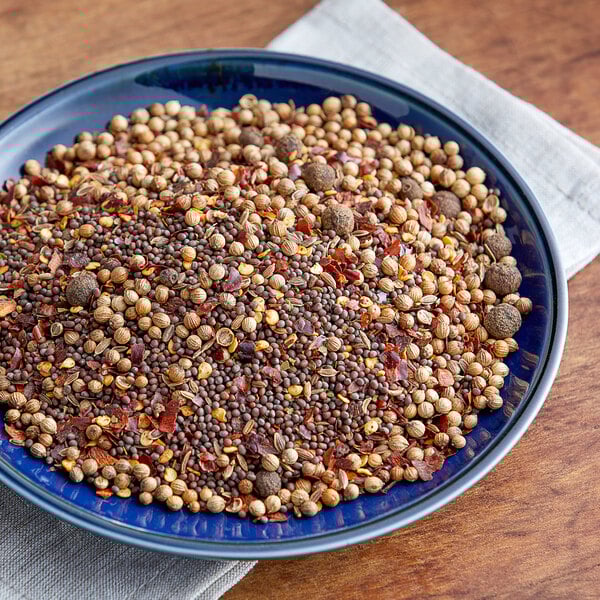 A blue bowl of Zatarain's dry crab boil mix and spices.
