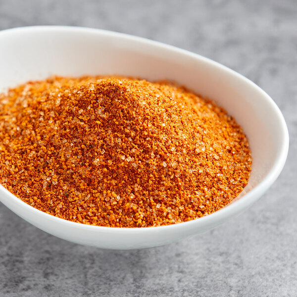 A bowl of orange Lawry's Chipotle Cinnamon Rub.