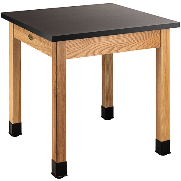 A National Public Seating science lab table with black legs and a black phenolic top.