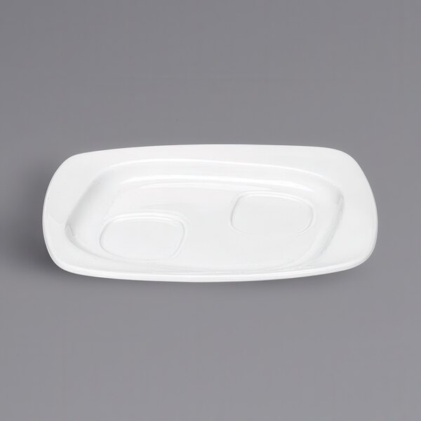 A bright white rectangular porcelain saucer with two ovals.