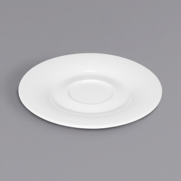 A close up of a Bauscher Avantgarde bright white porcelain saucer on a white plate.