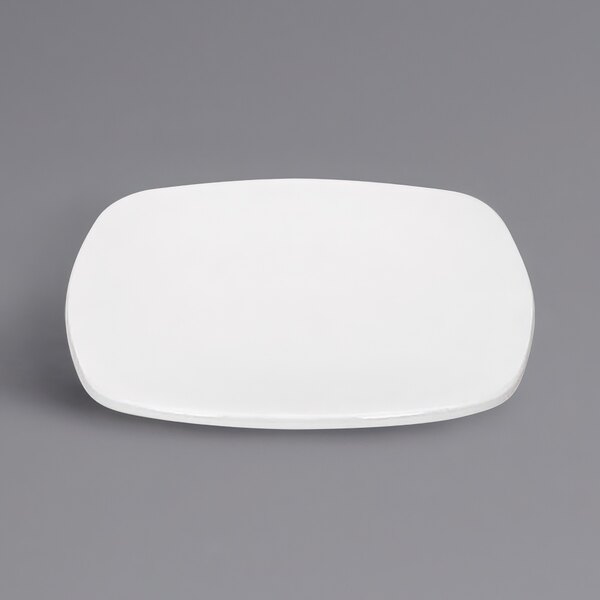 A white square Bauscher porcelain lid on a gray surface.