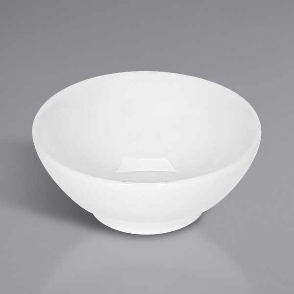 A white bowl on a gray surface.
