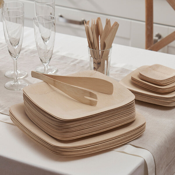 A table set with Bambu Veneerware wooden plates and utensils.