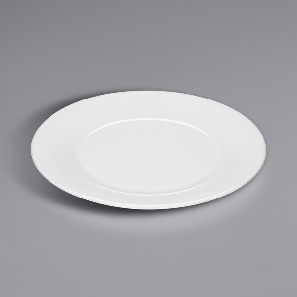 A Bauscher bright white porcelain plate with a wide rim on a gray surface.