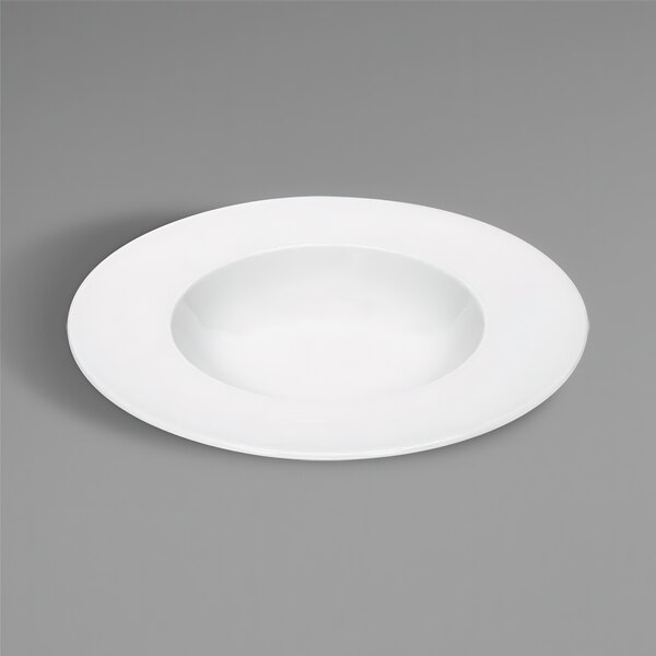 A Bauscher bright white porcelain deep plate with a wide rim on a gray surface.