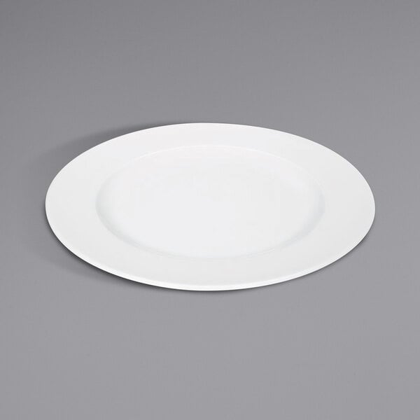 A Bauscher bright white porcelain plate with a wide rim on a gray surface.