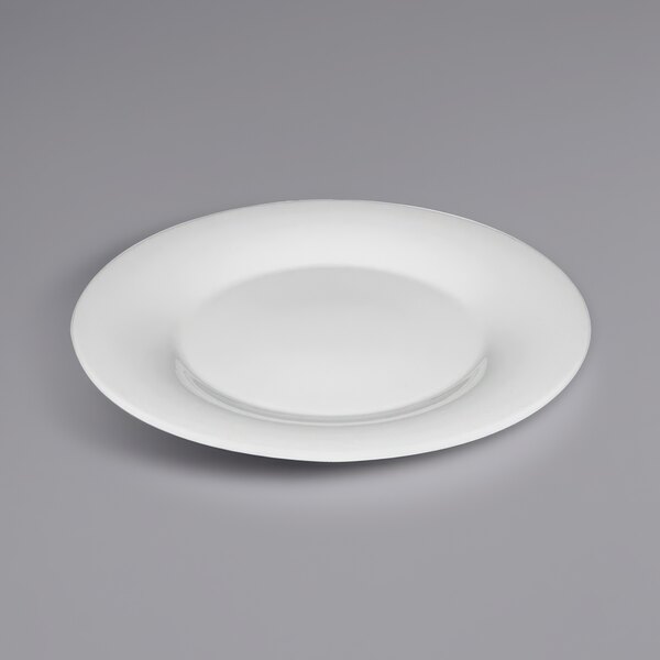 A Bauscher Hepp Avantgarde white porcelain plate with a wide rim on a gray surface.