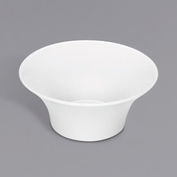 A Bauscher bright white porcelain bowl on a gray surface.
