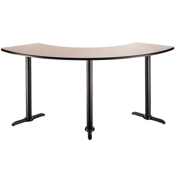 A National Public Seating curved cafe table with black legs.
