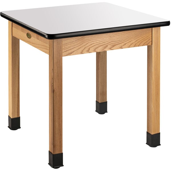 A National Public Seating science lab table with a white rectangular top on wood.