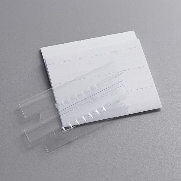 A close-up of clear plastic Pendaflex file folder tabs.