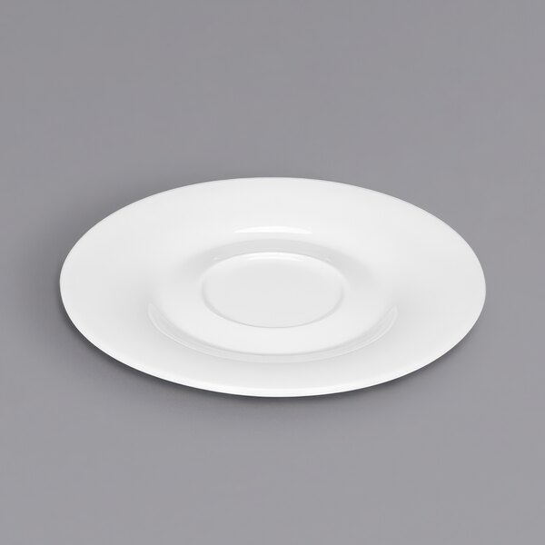 A Bauscher bright white round porcelain saucer on a white plate.