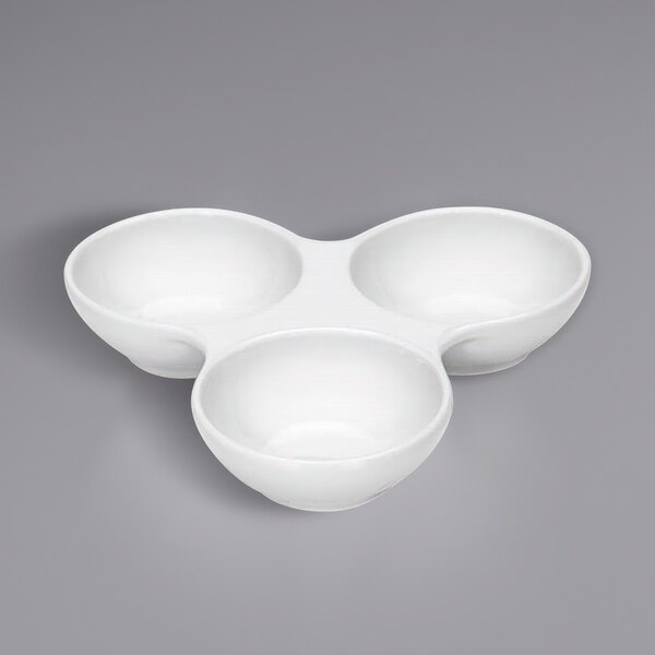 A white Bauscher by BauscherHepp cruet bowl on a gray surface.