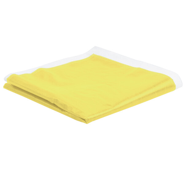 A yellow folded Intedge vinyl table cover on a white surface.
