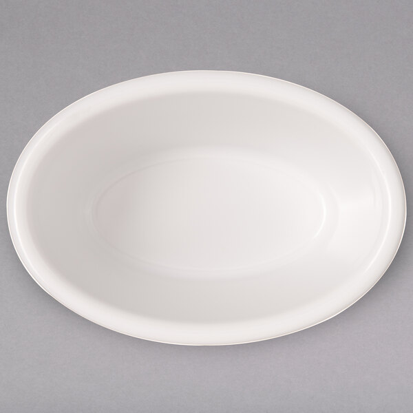 A white oval Carlisle ramekin on a gray surface.