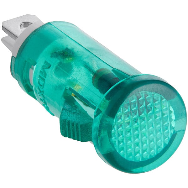 A close up of a green light with a white background.