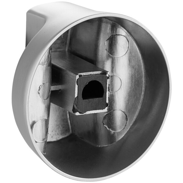 A metal knob with a hole in the middle.