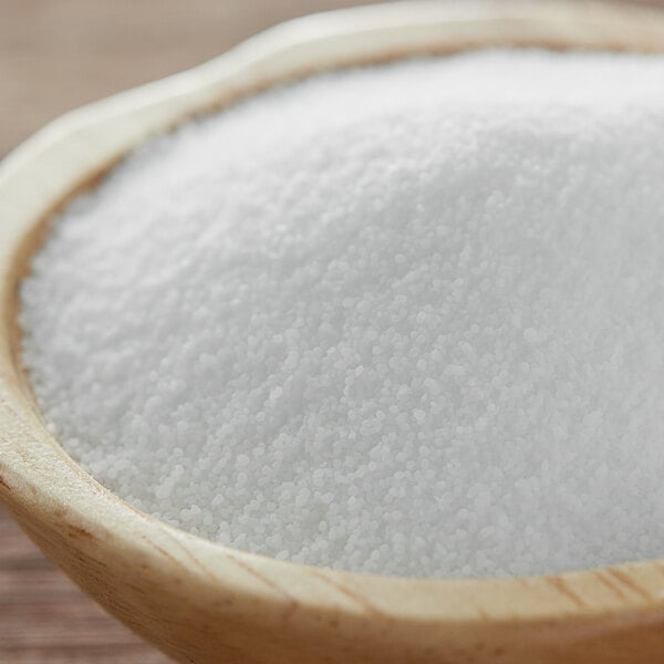 A bowl of LorAnn Oils Isomalt Crystals on a wooden table.