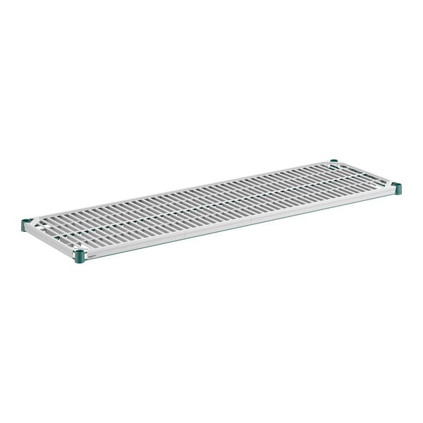A rectangular, metal wire shelf with a greenish frame and a slotted polymer mat insert.