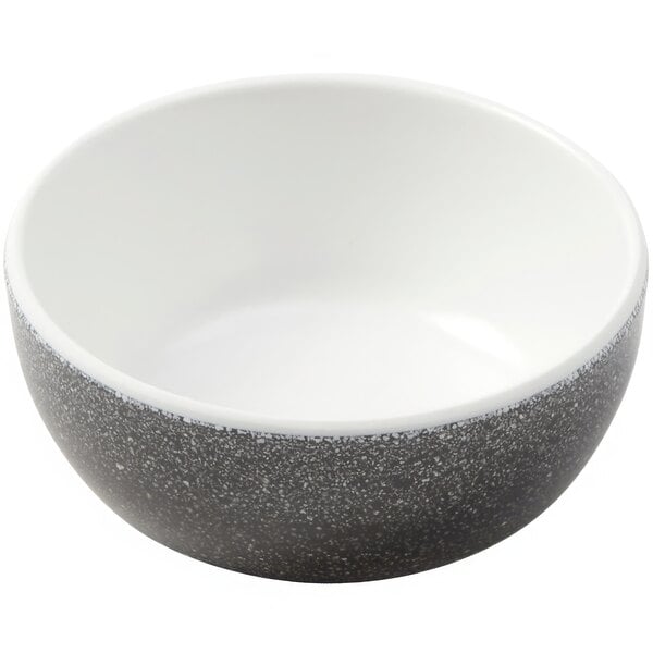 A white bowl with a black speckled design.