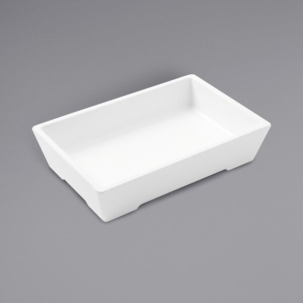 An American Metalcraft white rectangular melamine bowl on a gray surface.