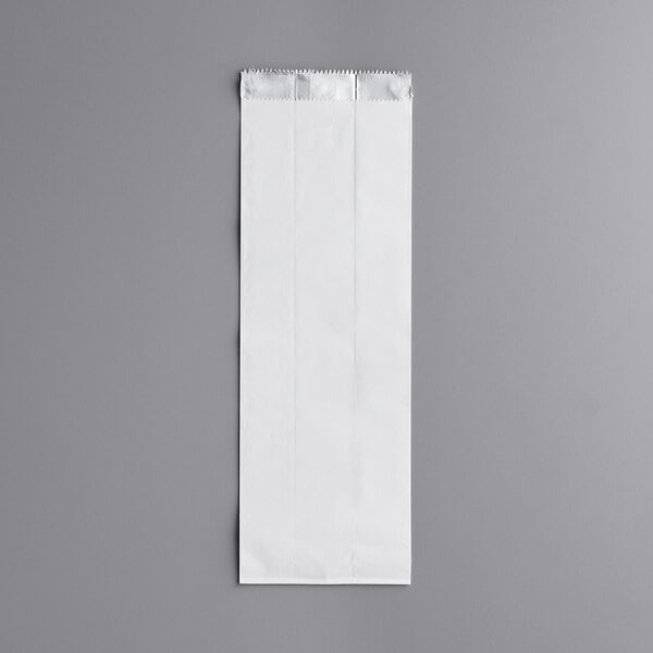 A white bag on a gray surface.