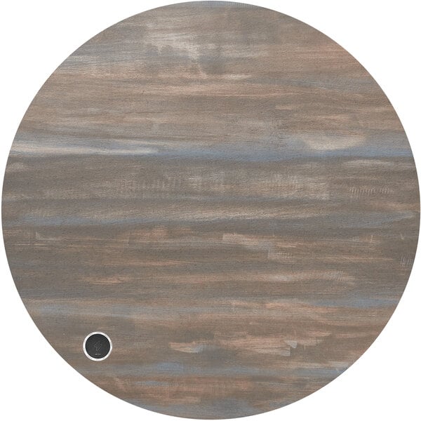 A BFM Seating Relic round chestnut melamine table top with a black circle on it.