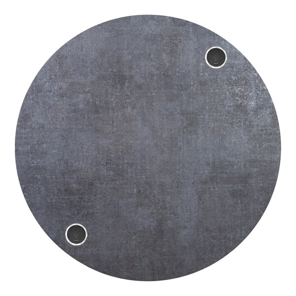 A BFM Seating Midtown round tabletop with wireless chargers and holes in it.