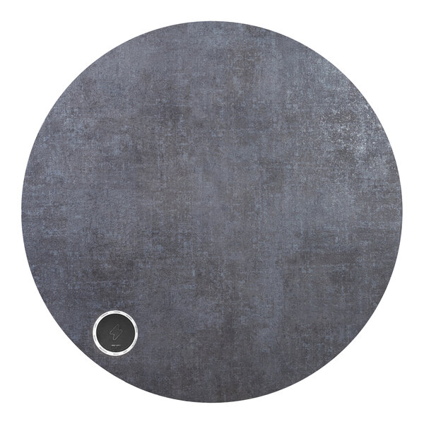 A circular grey BFM Seating Midtown tabletop with a round metal circle in the center.