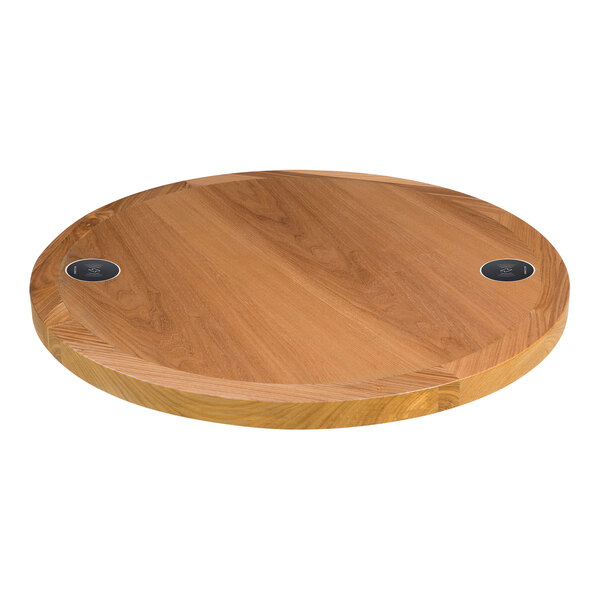 A BFM Seating round wooden table top with two wireless chargers.