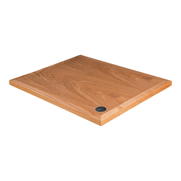 A BFM Seating square wooden table top with a round metal wireless charger.