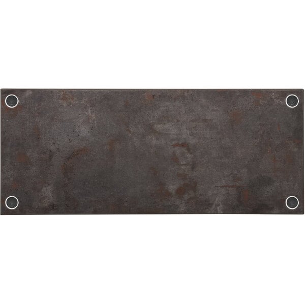 A BFM Seating Relic rectangular rustic copper melamine table top with wireless chargers and holes in it.