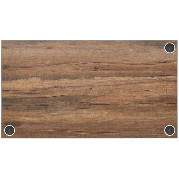 A wood grained BFM Seating Relic rectangular table top with metal circles.