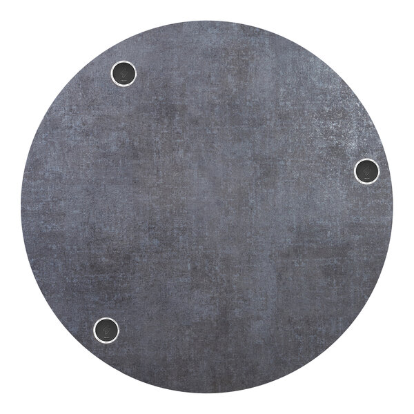 A BFM Seating round tabletop with wireless chargers and holes in it.